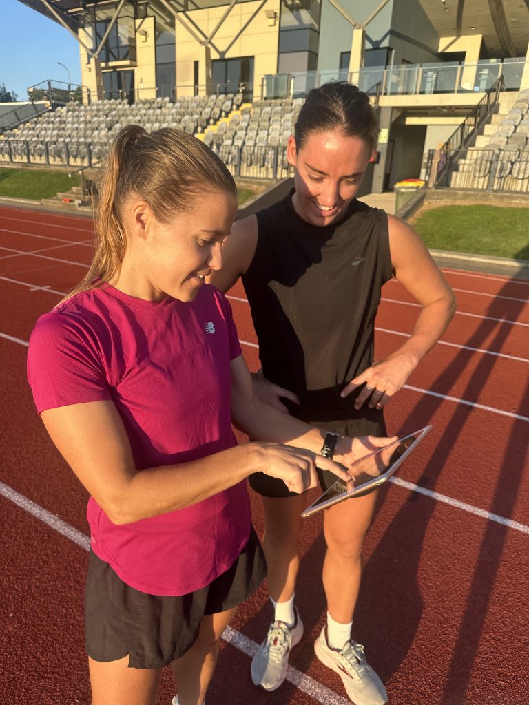 Coach and athlete at running track